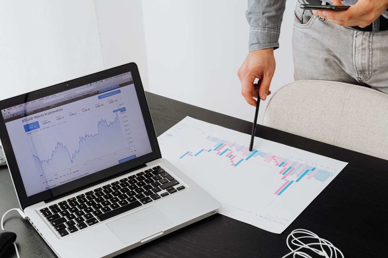 creative-03 Person analyzing cryptocurrency data using a laptop, highlighting financial insights.
